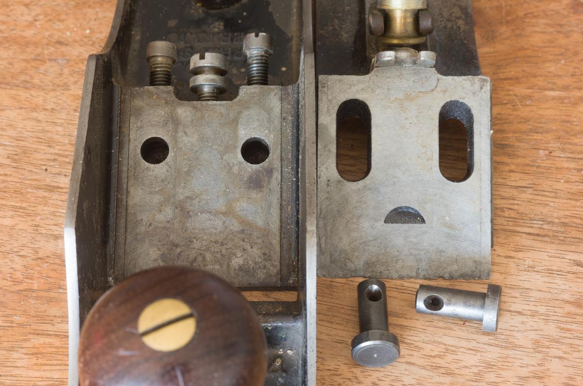 When the plane is disassembled the frog clamping pins and the wide bearing surfaces for solidly mounting the frog can be clearly seen