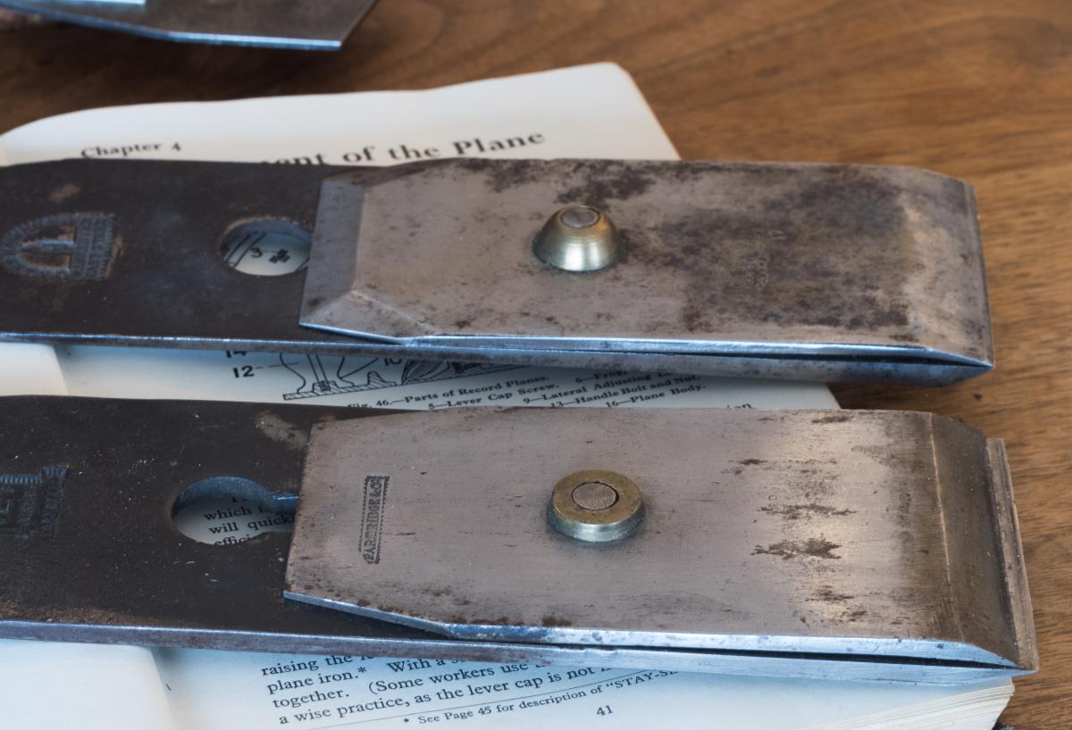 Two 19th century cap irons with soldered on brass nuts