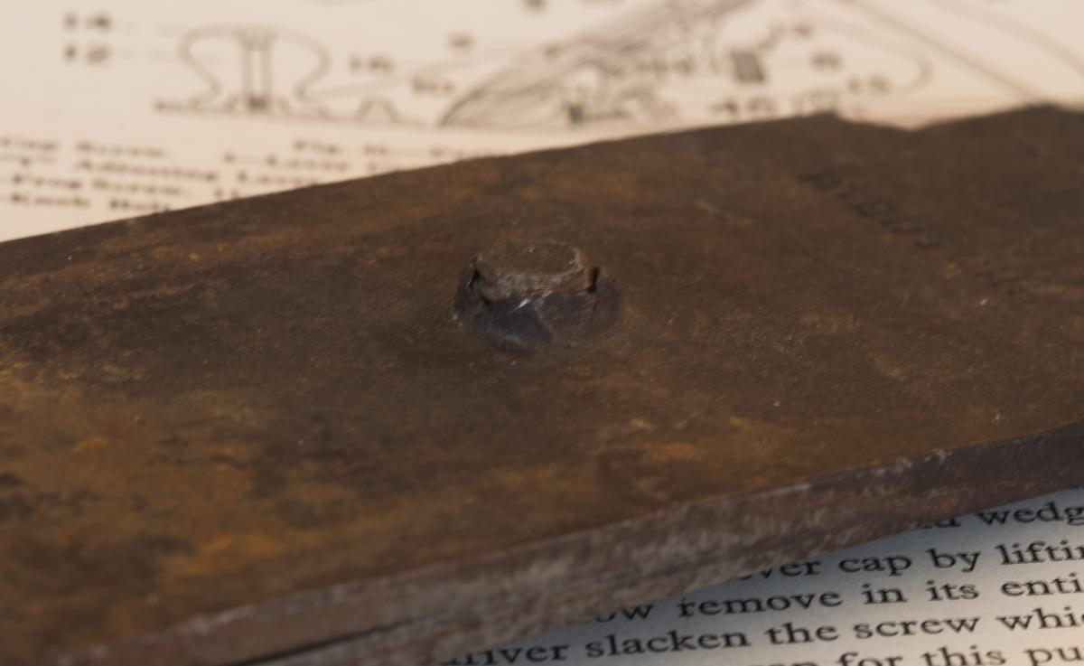 Detail of the punched in hole for the cap iron screw on the Butcher cap iron