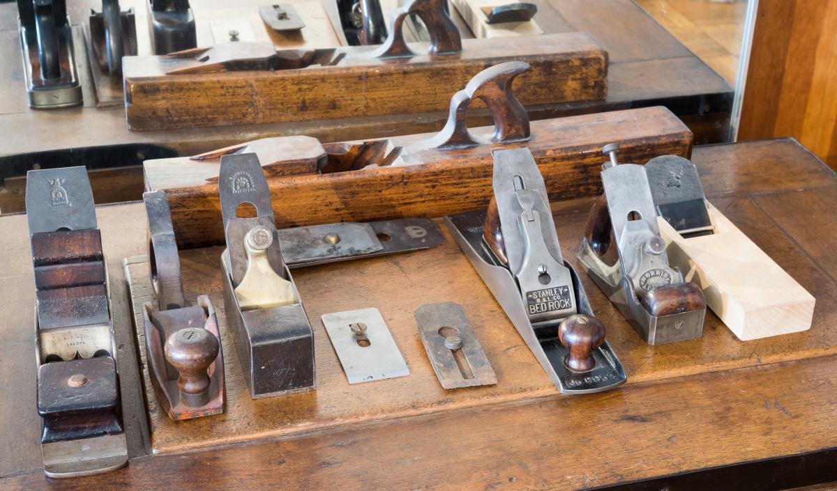 L-R - Panel Plane by Robert Towell c. 1830's;American Knowles patent plane C. 1840;Mathieson smooth plane C. 1860;Hock Cap Iron;W. Butcher cap iron from Knowles plane;Stanley 605 1/2 c. 1900; Norris A51 C.1914; Tsunesaburo 2005
