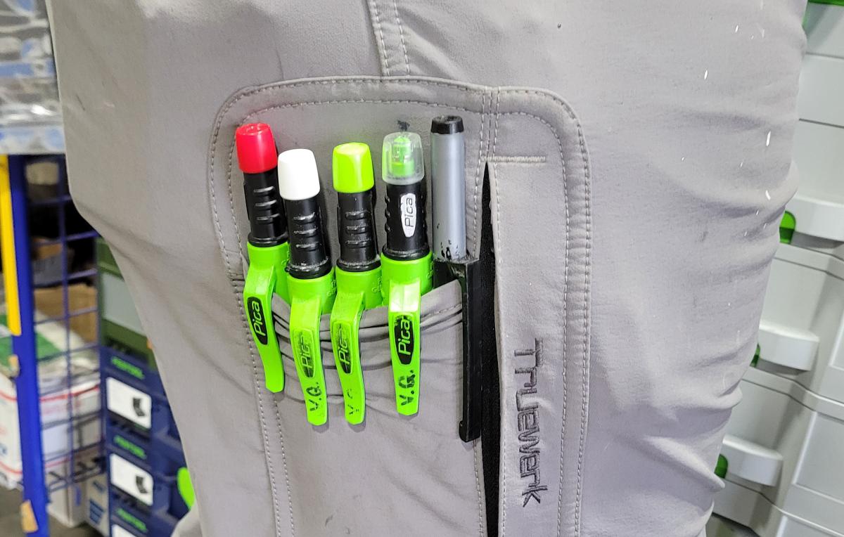 Four lead pencils in a craftsman's pocket. The caps are color coded to know which color is which