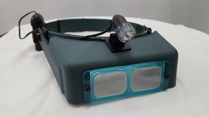 OptiVISOR&reg; DA - Precision Glass Binocular Magnifiers and Accessories - The OmniVisor with accessory clip-on light and battery pack.